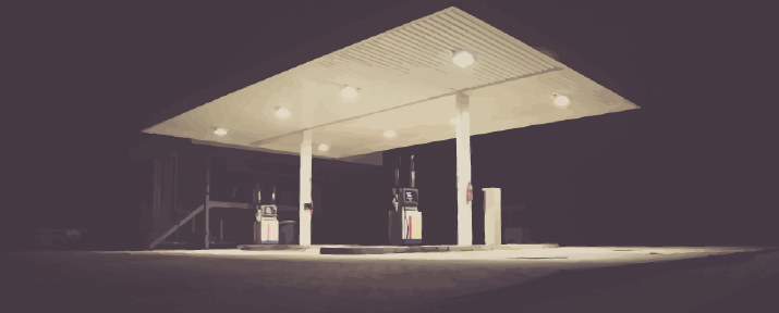 A picture of a petrol station at night.