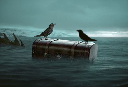 A picture of two crows sitting atop an old-fashioned suitcase that is floating in choppy water.